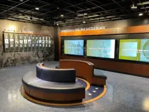 Honoring History: Exhibit Studios' Remarkable Civil War Battle Flag Exhibit Exhibit Studios Image of center round seats. Divide din two and large flag floor graphic under it for state of Pennsylvania