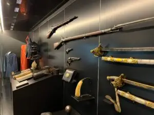 Honoring History: Exhibit Studios' Remarkable Civil War Battle Flag Exhibit Exhibit Studios rifles and swords on display noted horizontally.