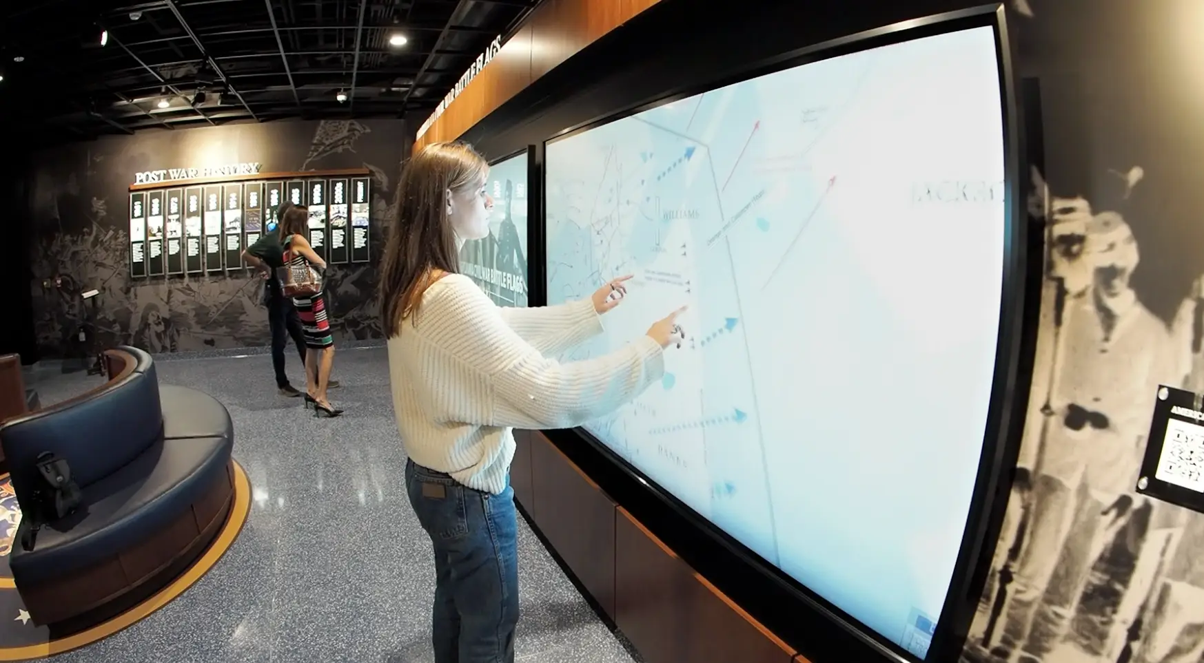 Honoring History: Exhibit Studios' Remarkable Civil War Battle Flag Exhibit Exhibit Studios Using two hands for large gestures on multi touch screen with civil war map.