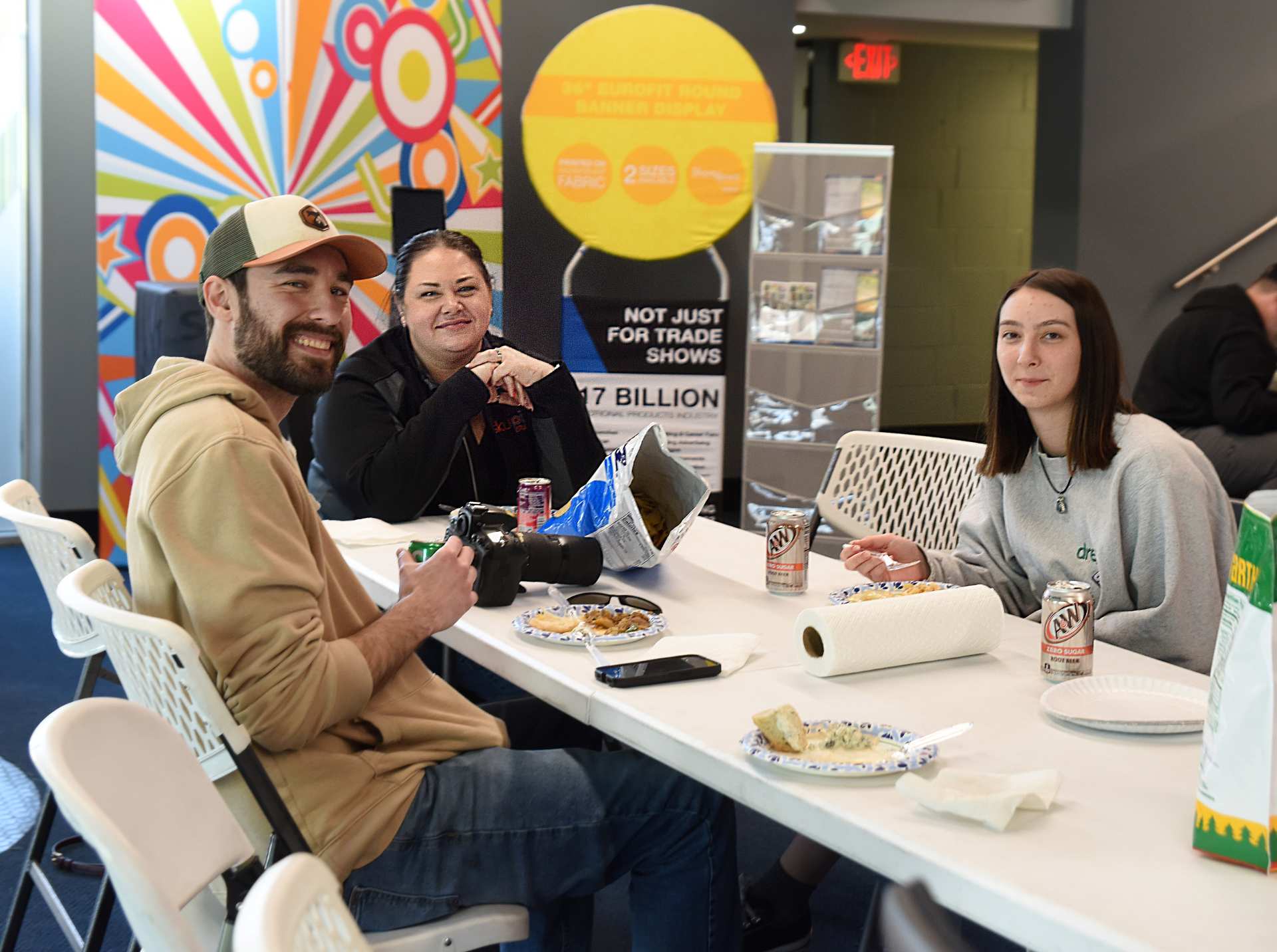 employees gathered around a table at a company celebration