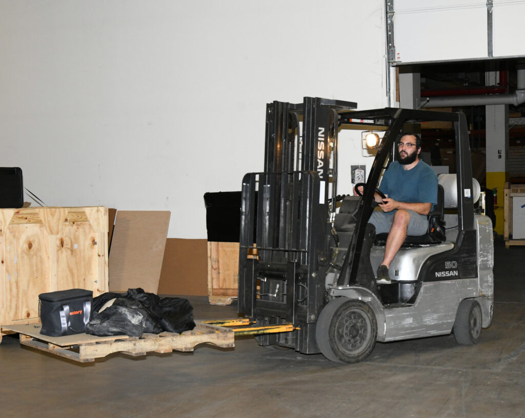 employee on forklift in warehouse