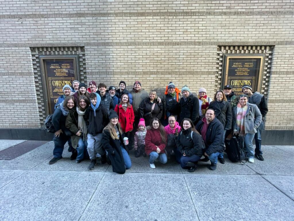 Exhibit Studios team taking a group photo during their holiday trip to NYC