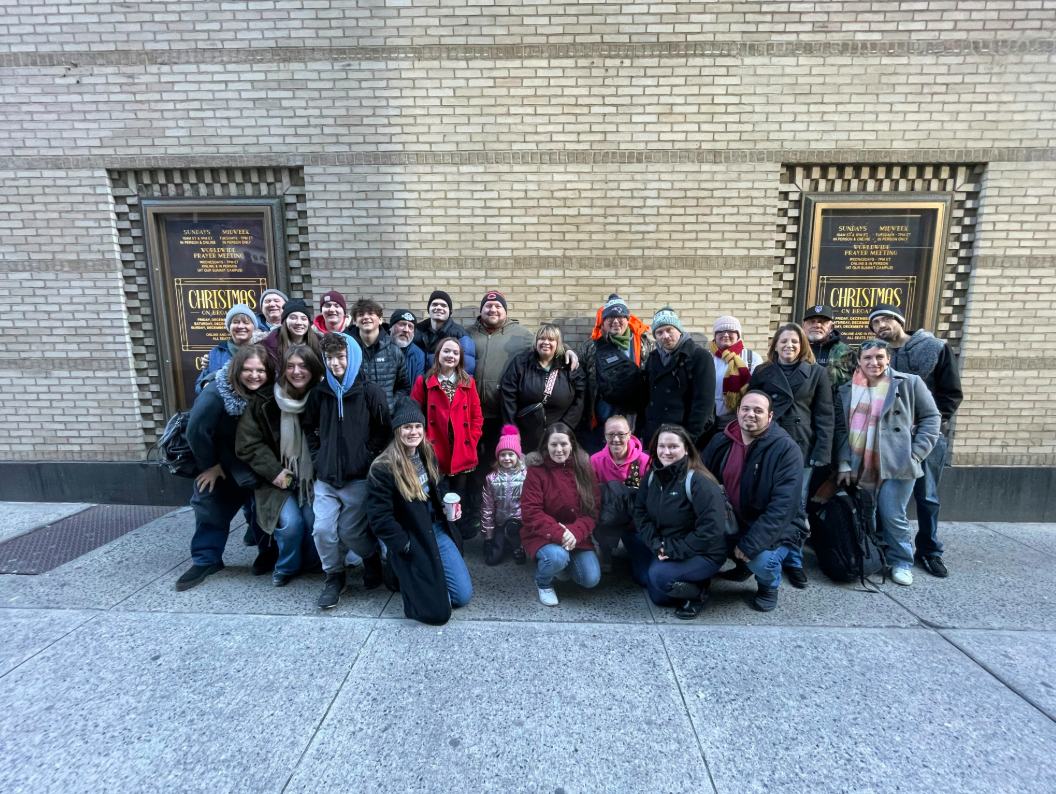 Exhibit Studios team taking a group photo during their holiday trip to NYC