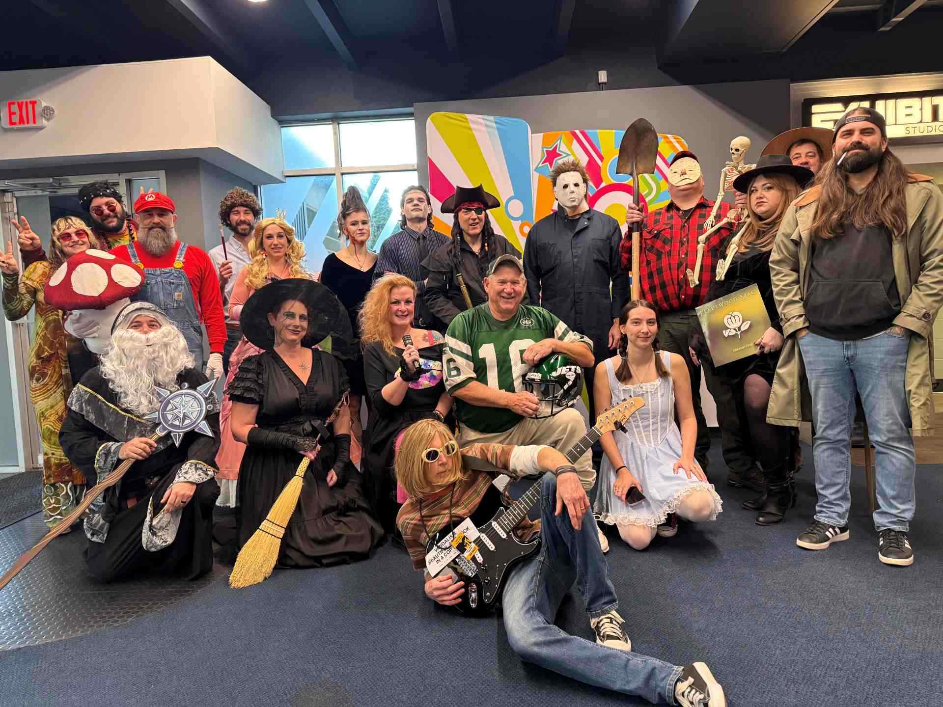 Exhibit Studios employees posing together for their 2025 Halloween costume contest