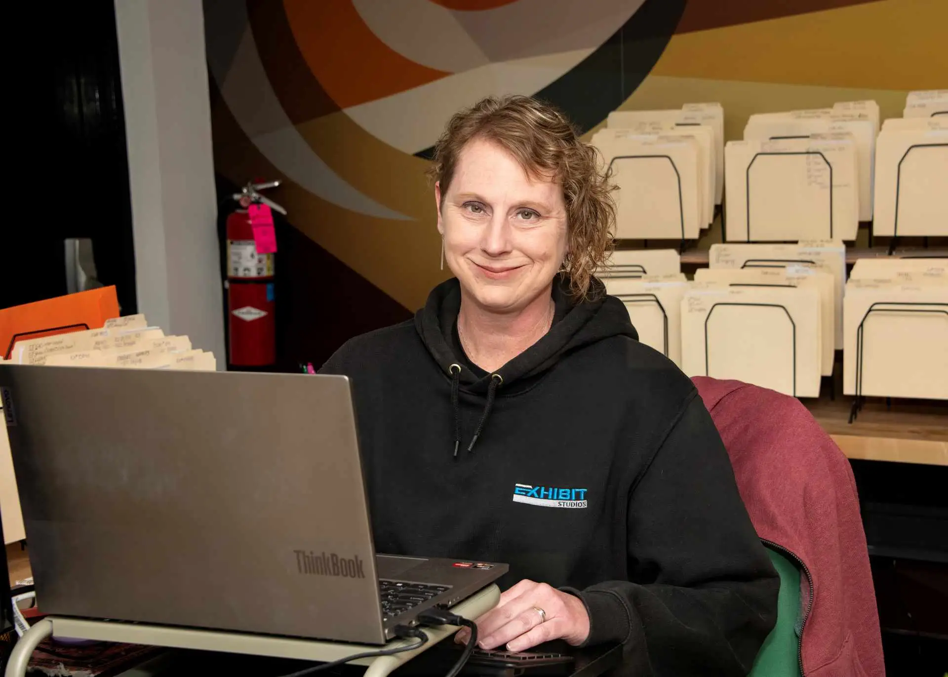 Exhibit Studios employee explaining trade show service order forms